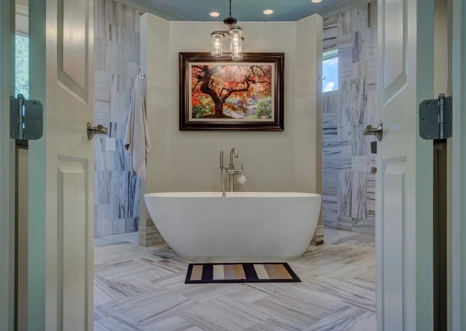 Freestanding tub in a marble-clad bathroom