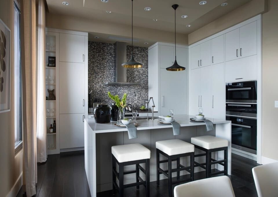 White modern kitchen with an island, pendant lights and bar stools