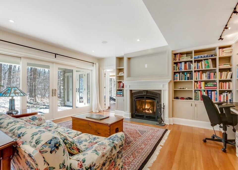 Sunny living room with built-in bookshelves and a fireplace